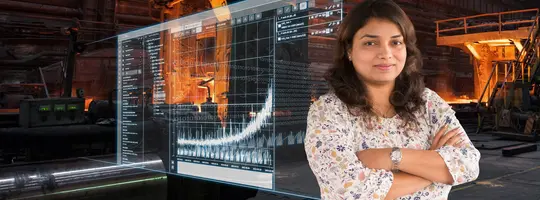 Person in a steel production facility with a digital condition monitoring dashboard displaying machine data.
